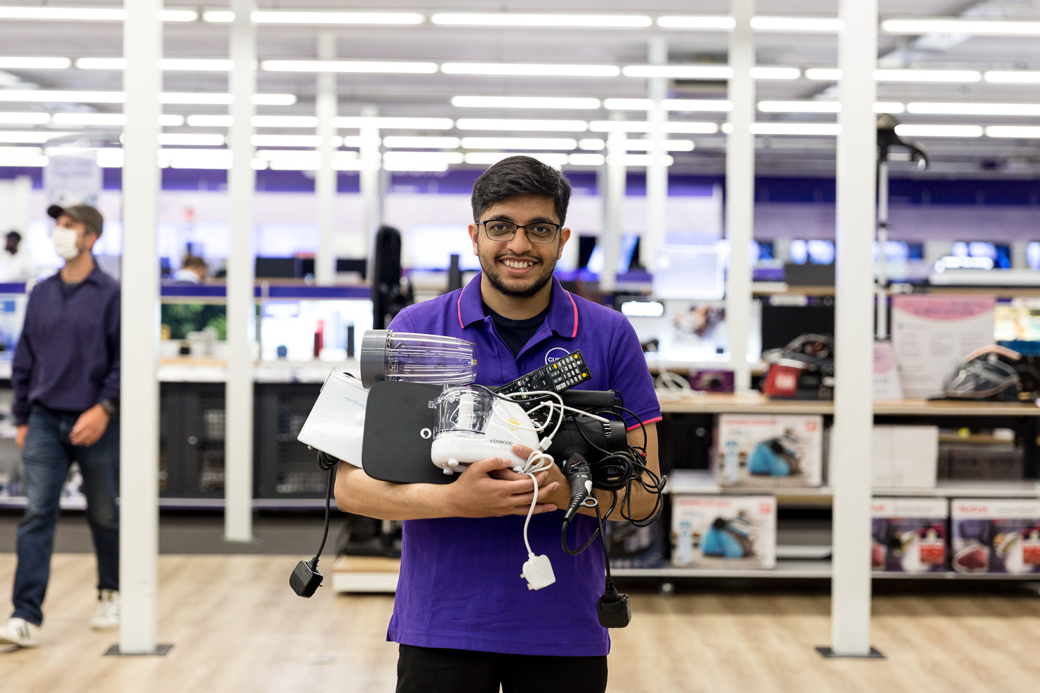 retail-colleague-holding-electronics-for-repair-recycling-1